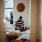 doorway framed shot of man sitting on his bed, working on his laptop